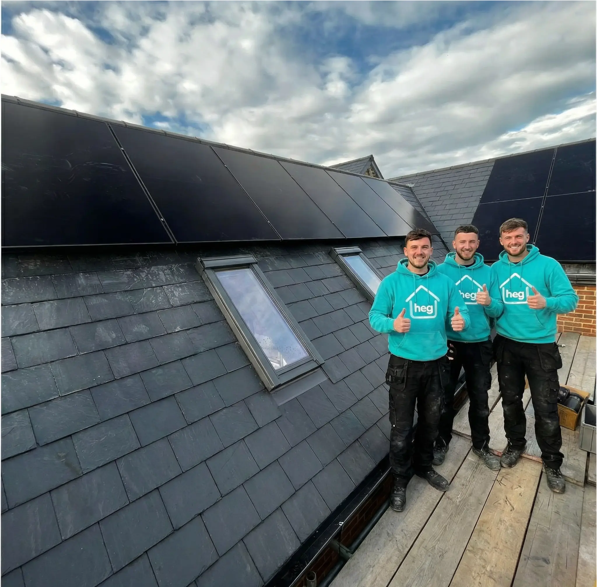 Home Energy Group team member working on a solar roof installation